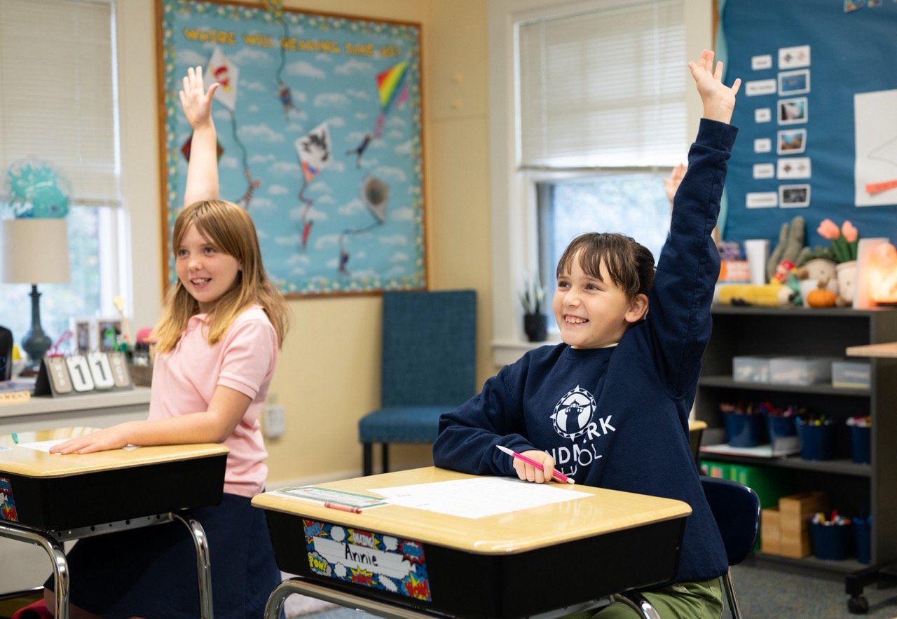 students advocating in class raising hands