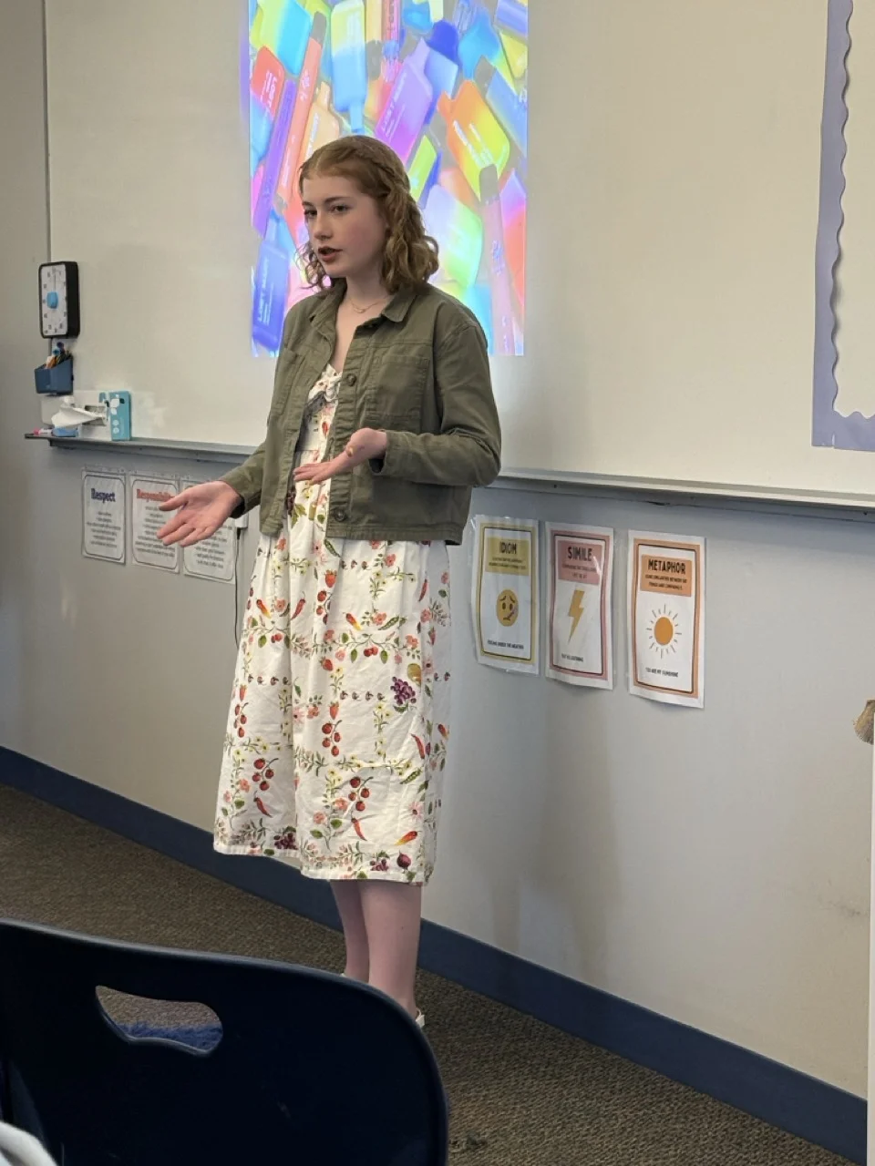 girl presenting in communications class working on literacy skills