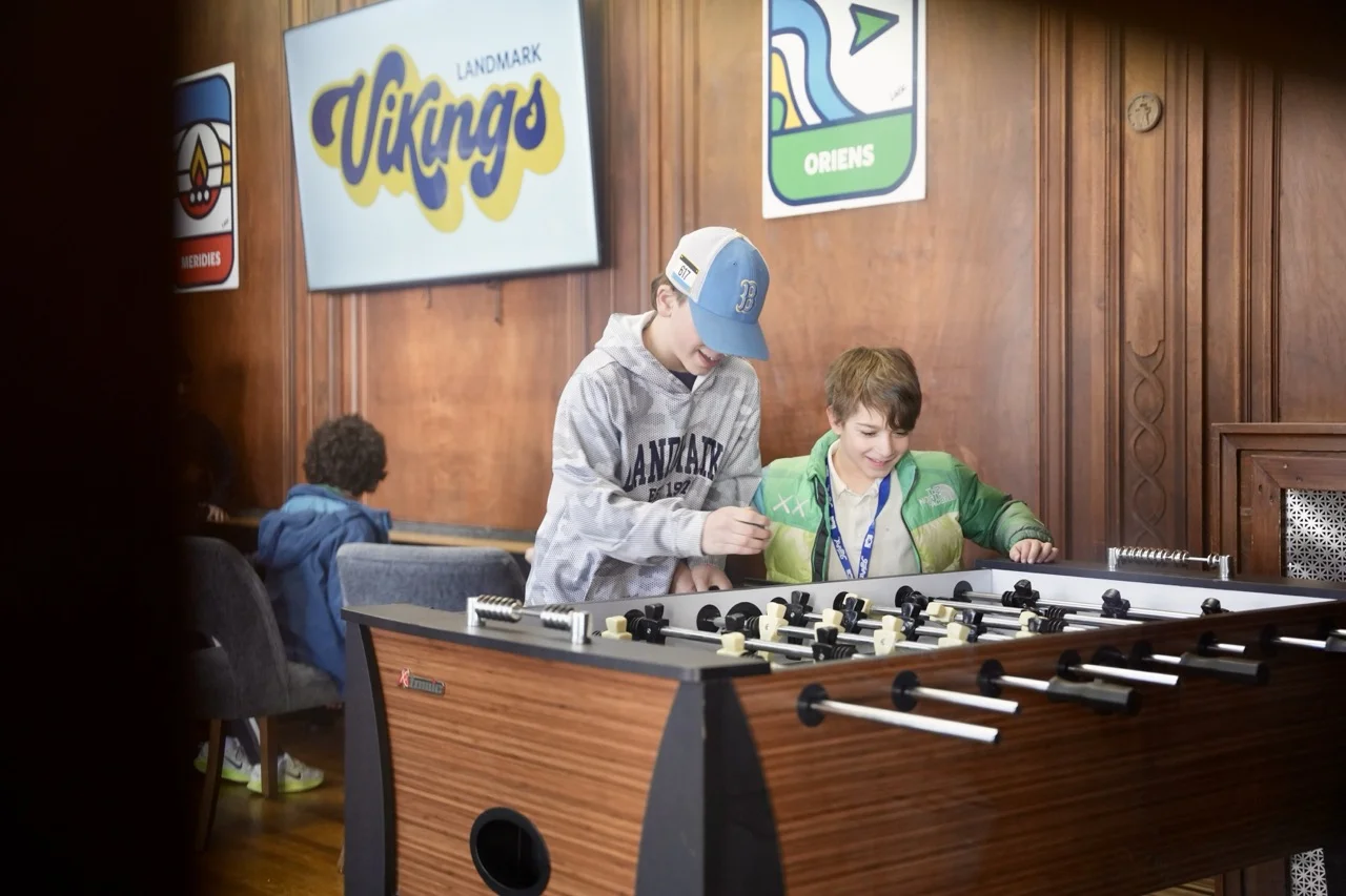 boys playing games foosball in the lounge