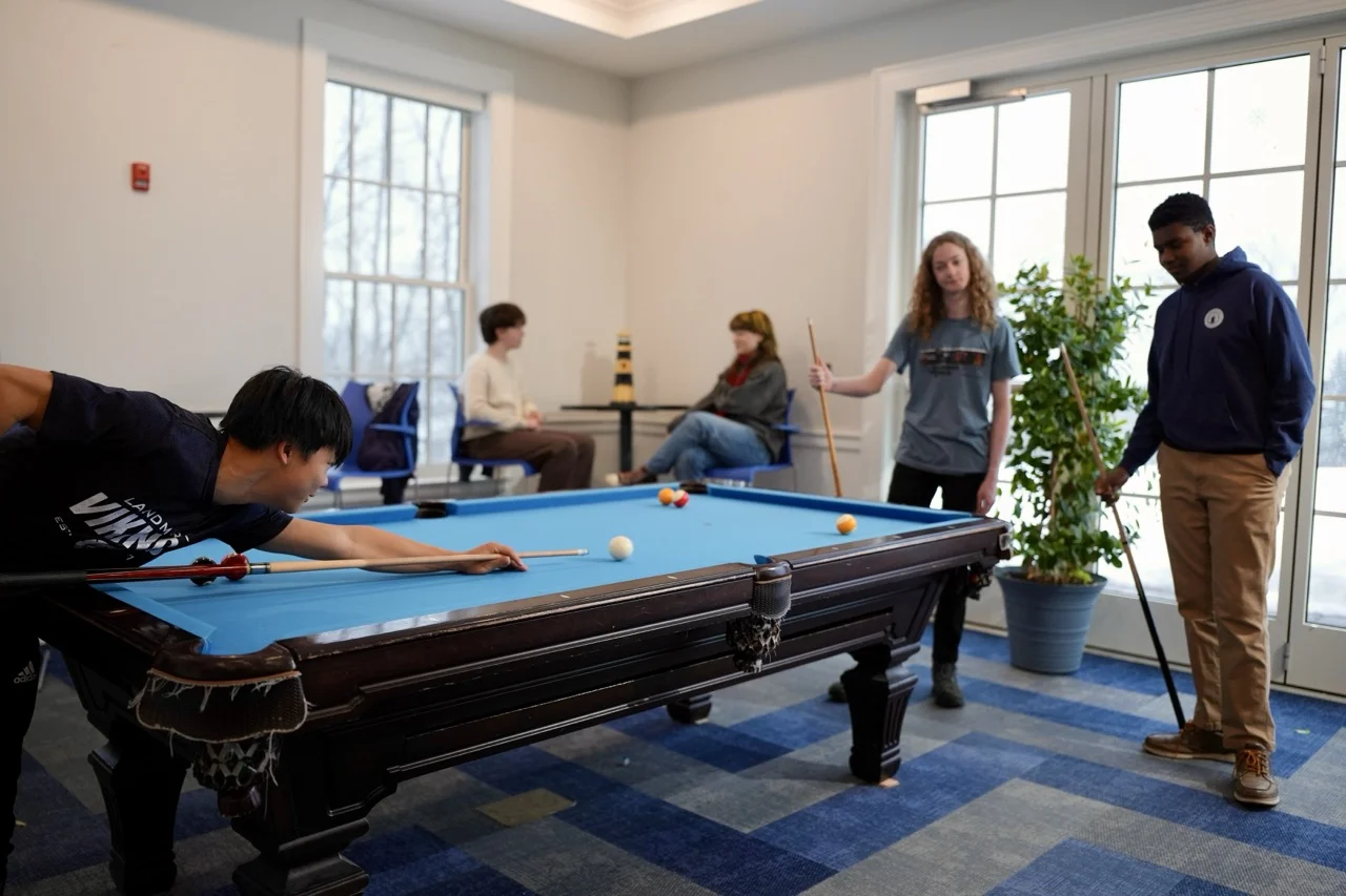 boys playing pool in the student lounge