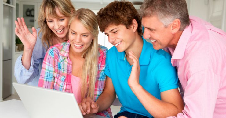 smiling family using laptop